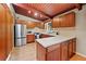 Updated kitchen with stainless appliances and wooden cabinetry, offering a practical and stylish cooking space at 3408 Chestnut Dr, Doraville, GA 30340