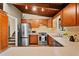 Kitchen with stainless steel appliances, wood cabinets, and white countertops at 3408 Chestnut Dr, Doraville, GA 30340