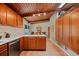 Kitchen with light countertops, wood cabinets, tile floors, and wood ceiling at 3408 Chestnut Dr, Doraville, GA 30340