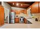 Well-lit kitchen features stainless steel appliances, wood cabinets, and ample countertop space for all your cooking needs at 3408 Chestnut Dr, Doraville, GA 30340