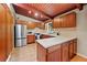 Kitchen with stainless steel appliances, wood cabinets, and wood ceiling at 3408 Chestnut Dr, Doraville, GA 30340
