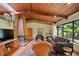 Bright living room featuring a unique fireplace, wood ceiling, tile floors and large windows at 3408 Chestnut Dr, Doraville, GA 30340