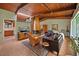 Inviting living room with wood ceiling, brick fireplace, tile floors, and lots of natural light at 3408 Chestnut Dr, Doraville, GA 30340