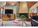 Charming living room featuring a stylish brick fireplace, a modern TV, and wood-beamed ceilings at 3408 Chestnut Dr, Atlanta, GA 30340