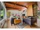 Bright living room featuring a unique fireplace, wood ceiling, tile floors and large windows at 3408 Chestnut Dr, Doraville, GA 30340