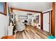 Bright open living room with wood floors, a comfortable chair, and an open layout with an art studio at 3408 Chestnut Dr, Atlanta, GA 30340