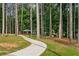 Scenic park pathway lined with tall trees, a playground, and covered seating area at 3408 Chestnut Dr, Doraville, GA 30340
