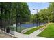 Community tennis courts with blue hard courts and black fencing at 3408 Chestnut Dr, Doraville, GA 30340