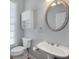 Clean and tidy bathroom with gray walls, a white toilet, a sink with vanity, a mirror, and storage space at 1286 Creekside Se Ter, Smyrna, GA 30082