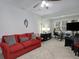 Spacious bonus room is furnished with a red couch and equipped for entertainment at 1286 Creekside Se Ter, Smyrna, GA 30082