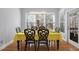 Inviting dining room featuring hardwood floors, a large window with blinds, and a charming chandelier at 1286 Creekside Se Ter, Smyrna, GA 30082