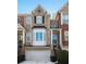 Beautiful townhome exterior with brick, columns, shutters, and a well-maintained front yard at 1286 Creekside Se Ter, Smyrna, GA 30082