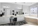 Bright bathroom featuring double sinks, a soaking tub, and an enclosed walk-in shower at 1286 Creekside Se Ter, Smyrna, GA 30082