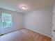 A bright bedroom with a window providing ample natural light and neutral carpet at 1531 Iris Walk, Jonesboro, GA 30238