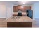 Kitchen with island sink, ample counter space, updated cabinets, and black appliances at 1531 Iris Walk, Jonesboro, GA 30238