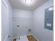 Practical laundry room with overhead shelving and utility connections at 1531 Iris Walk, Jonesboro, GA 30238