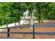 Charming single-story home with a long driveway and a well-maintained, landscaped front yard and black country fence at 1960 York Dr, Canton, GA 30114