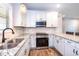 Modern kitchen boasts stainless steel appliances, granite counters and bright white cabinetry at 1960 York Dr, Canton, GA 30114