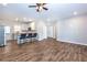 Open-concept living room showcasing modern kitchen with an island and bar stools, seamlessly connected by stylish wood flooring at 1960 York Dr, Canton, GA 30114
