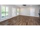 Bright living room with wood flooring, showcasing windows and a seamless connection to other rooms at 1960 York Dr, Canton, GA 30114