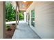 Inviting covered porch featuring a stylish wood ceiling, attractive lighting fixtures, and a view of the surrounding greenery at 1960 York Dr, Canton, GA 30114