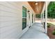 Charming covered porch with wood ceiling, featuring stylish lighting fixtures and ample space for outdoor seating at 1960 York Dr, Canton, GA 30114