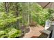 Scenic backyard with a tranquil pond, lush greenery, and wooded views from the deck at 3284 Bakers Mill Ct, Dacula, GA 30019