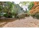Backyard view of a two-story house with a deck, stairs, and a pond at 3284 Bakers Mill Ct, Dacula, GA 30019