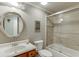 Bathroom featuring a tub shower combo with an oval mirror and wooden vanity at 3284 Bakers Mill Ct, Dacula, GA 30019