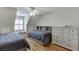 Bedroom with an accent headboard bed, window bench, ceiling fan, and dresser at 3284 Bakers Mill Ct, Dacula, GA 30019