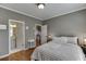 Bedroom with hardwood floors, neutral paint, and access to an en-suite bathroom and staircase at 3284 Bakers Mill Ct, Dacula, GA 30019