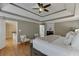 This bedroom features a trey ceiling, hardwood floors, a fireplace, and natural light at 3284 Bakers Mill Ct, Dacula, GA 30019