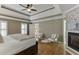This bedroom features a trey ceiling, hardwood floors, a fireplace, and natural light at 3284 Bakers Mill Ct, Dacula, GA 30019