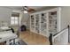 Bonus room with built-in bookshelves, hardwood floors, and a comfortable seating area at 3284 Bakers Mill Ct, Dacula, GA 30019