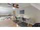 Open concept bonus room with hardwood floors, ceiling fan, and separate desk areas at 3284 Bakers Mill Ct, Dacula, GA 30019