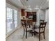 Dining area with a glass table, tile floor, and proximity to the kitchen at 3284 Bakers Mill Ct, Dacula, GA 30019