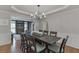 Spacious dining area with hardwood floors, a large table, and an open flow to the living space at 3284 Bakers Mill Ct, Dacula, GA 30019