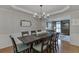 Formal dining room with a large table, chair seating for eight, and traditional chandelier at 3284 Bakers Mill Ct, Dacula, GA 30019