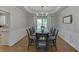 Formal dining room with a large table, elegant chandelier, and wainscoting details at 3284 Bakers Mill Ct, Dacula, GA 30019