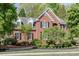 Elegant brick home with black shutters and a beautifully landscaped front yard at 3284 Bakers Mill Ct, Dacula, GA 30019