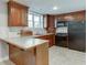 Kitchen featuring wood cabinets and black appliances at 3284 Bakers Mill Ct, Dacula, GA 30019