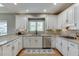 Spacious kitchen featuring white cabinets, granite countertops, and stainless steel appliances at 3284 Bakers Mill Ct, Dacula, GA 30019