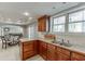 Kitchen features wood cabinets, double sink, and a view of the dining area through large windows at 3284 Bakers Mill Ct, Dacula, GA 30019