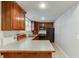Cozy kitchen featuring wooden cabinets, stone tile backsplash, black appliances, and generous countertop space at 3284 Bakers Mill Ct, Dacula, GA 30019