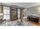 Bright living room with large windows, hardwood floors, and stylish decor at 3284 Bakers Mill Ct, Dacula, GA 30019