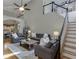 Open-concept living room with hardwood floors, neutral paint, ceiling fan, and staircase leading to the second floor at 3284 Bakers Mill Ct, Dacula, GA 30019