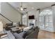 Bright living room with a fireplace, vaulted ceilings, and large windows at 3284 Bakers Mill Ct, Dacula, GA 30019