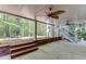 Covered patio with ceiling fans, brick supports, and a view of the wooded area at 3284 Bakers Mill Ct, Dacula, GA 30019