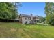Back exterior featuring a fenced yard, a deck, and a well-maintained lawn at 3792 Refinement Way, Douglasville, GA 30135