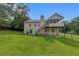 Back exterior featuring a fenced yard, a deck, and a well-maintained lawn at 3792 Refinement Way, Douglasville, GA 30135